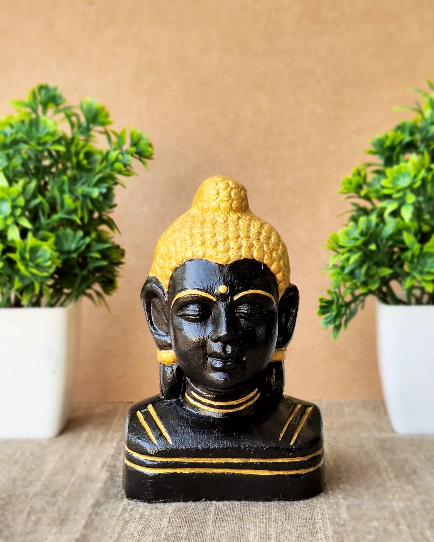 Black and golden calm buddha face statue